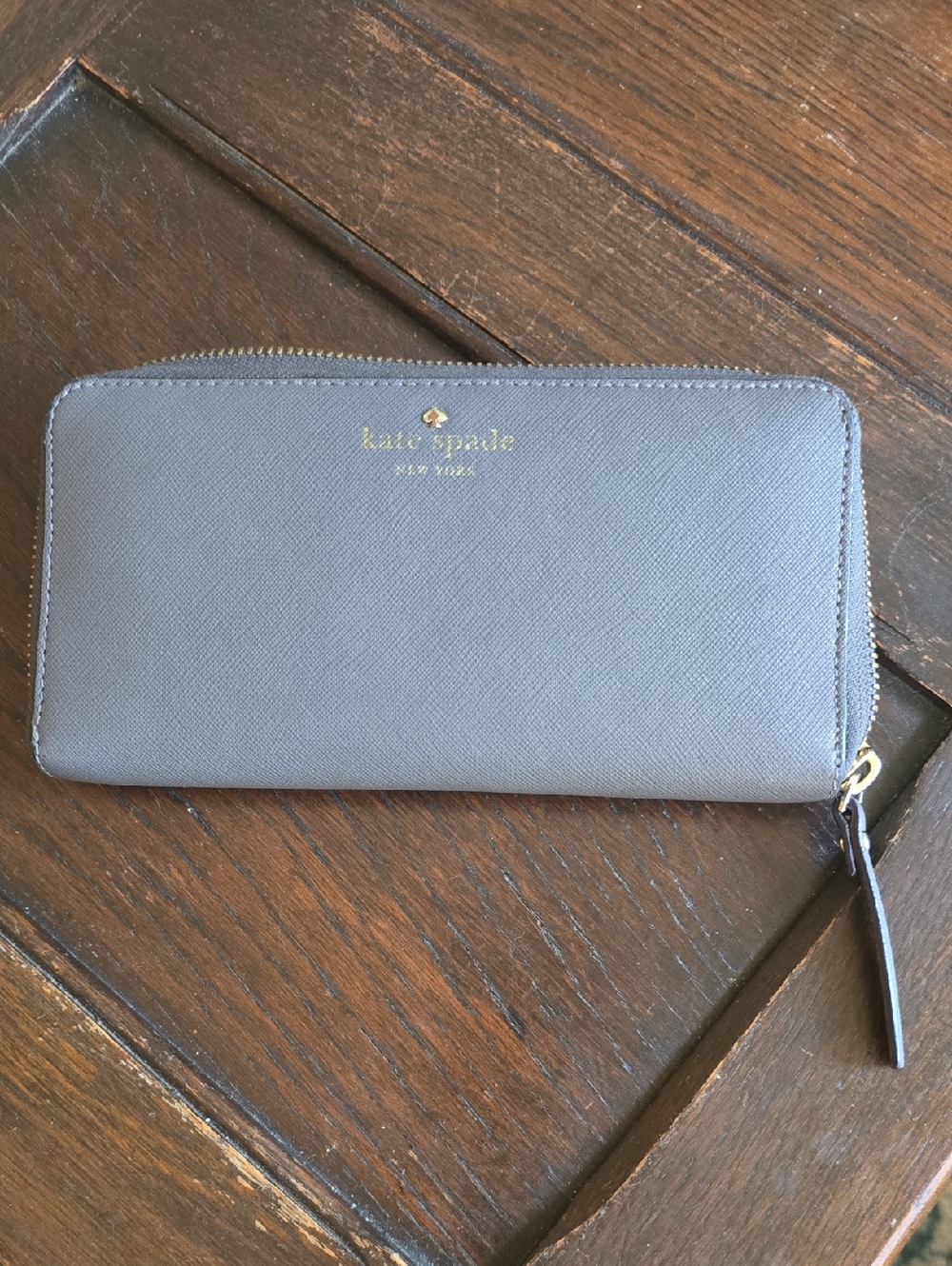 kate spade gray zip-around  wallet with gold logo